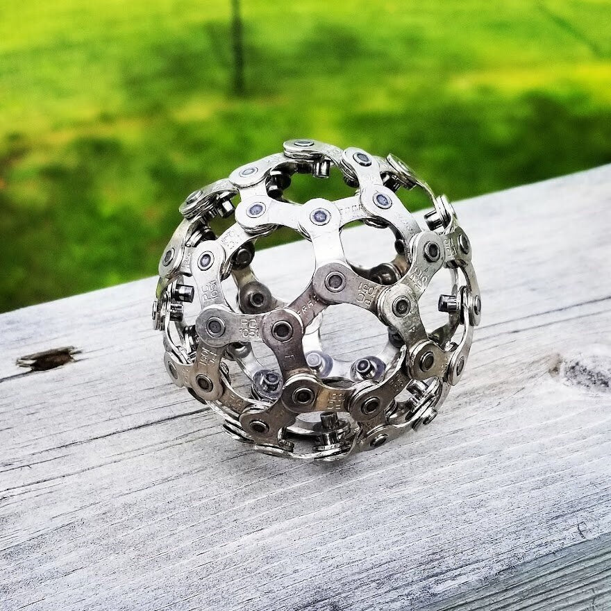 Unique gift for biker, mountain bike chain ball outside.